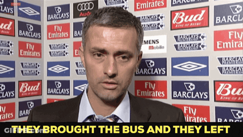 Man By Wall With Barclays And Emirates Ads GIF