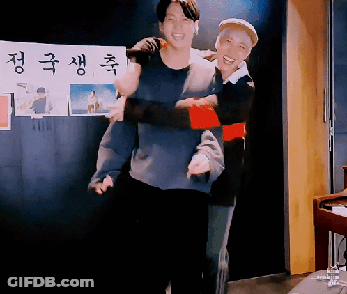 Man Carrying Another Man In Front Of Korean Sign GIF