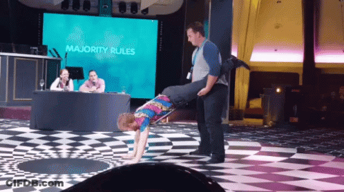 Man Carrying Another Man On Shoulders In Front Of Majority Rules Screen GIF