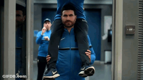 Man Carrying Another Man On Shoulders In Gym GIF