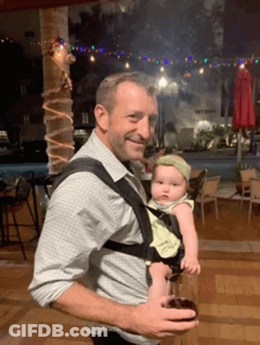 Man Carrying Baby Holding Glass Of Wine GIF