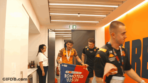 Man Carrying Banner Saying Promoted 025/26 GIF