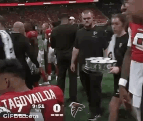 Man Carrying Beer Tray On Football Field GIF