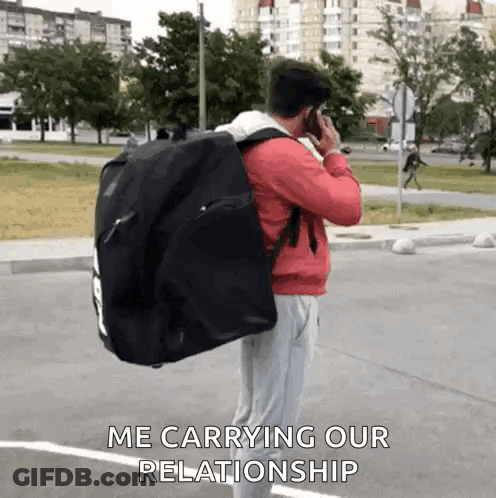 Man Carrying Black Bag Talking On Cell Phone GIF