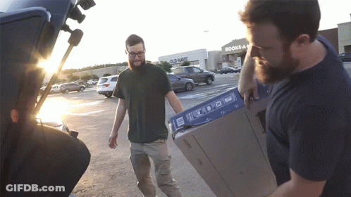 Man Carrying Box In Front Of Old Navy Store GIF