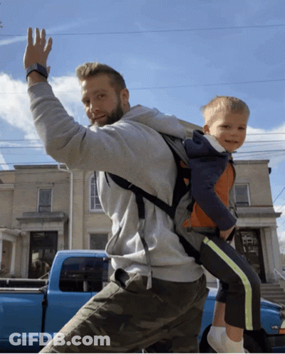 Man Carrying Child On Back In Front Of Blue Truck V8 GIF