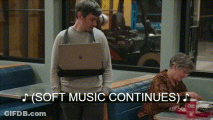 Man Carrying Laptop In Diner GIF