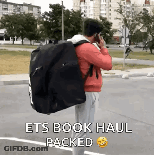 Man Carrying Large Black Bag GIF