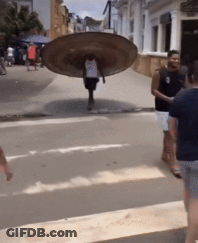 Man Carrying Large Plate On Back GIF