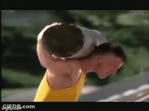 Man Carrying Large Rock On Shoulders GIF