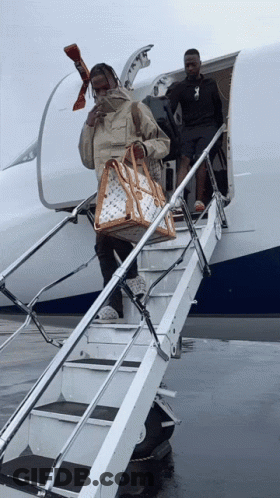 Man Carrying Louis Vuitton Bag Walking Down Stairs GIF