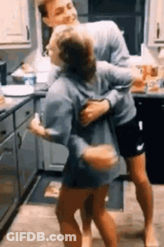 Man Carrying Woman In Kitchen GIF