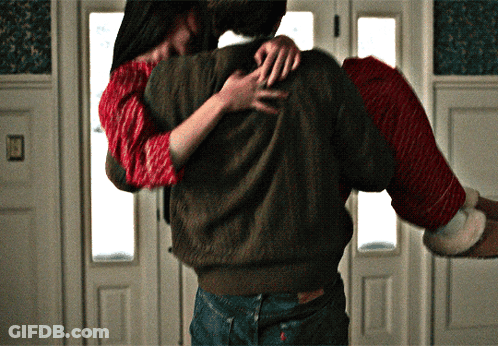 Man Carrying Woman In Santa Sweater GIF
