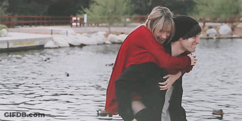 Man Carrying Woman On Back At Lake GIF