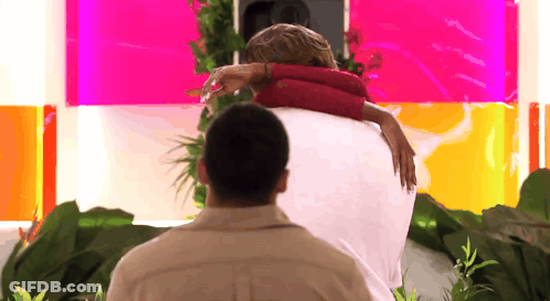 Man Carrying Woman On Back Pink Wall GIF