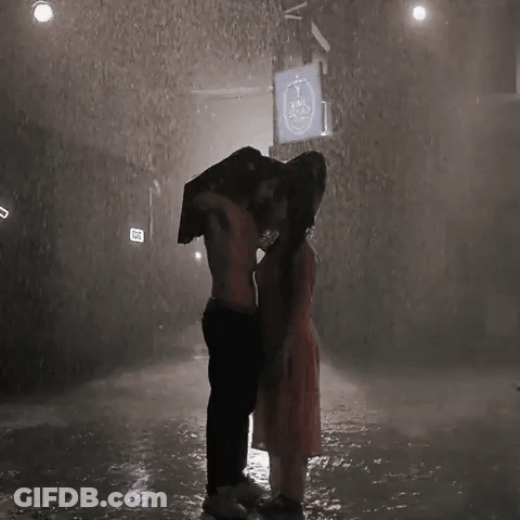 Man Carrying Woman On His Back In Rain GIF