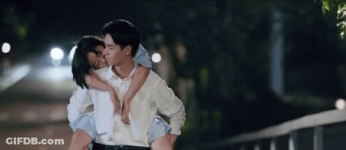 Man Carrying Woman On Shoulders Kissing GIF