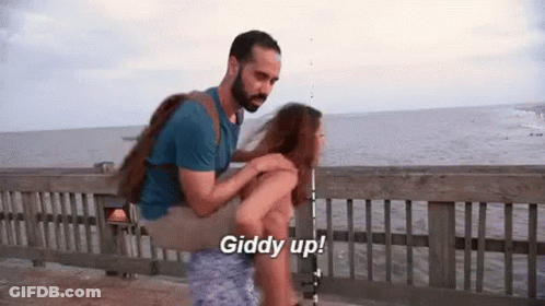 Man Carrying Woman On Shoulders GIF