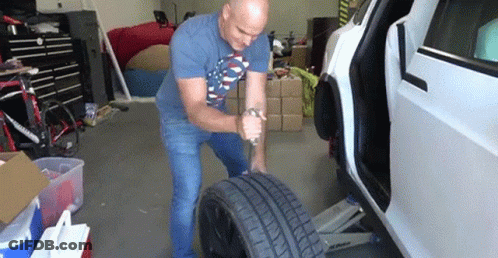 Man Changing Tire On Tesla Model S GIF