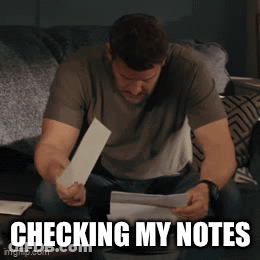 Man Checking Notes On Bed GIF