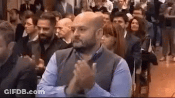 Man Clapping Hands In Front Of Crowd At Conference GIF