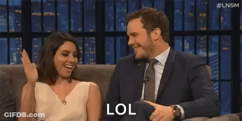 Man Clapping While Woman Says LOL On Couch GIF