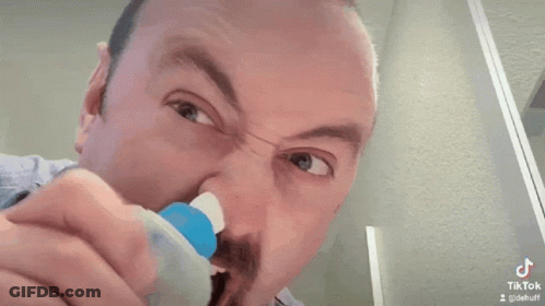 Man Cleaning Nose With Toothbrush GIF