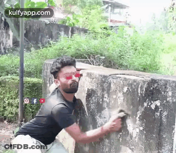 Man Cleaning Wall With Brush GIF