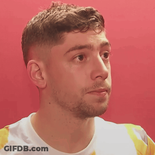Man Close Up Against Red Wall GIF