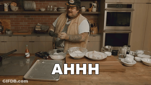 Man Cooking In Kitchen With Ahhh On Counter GIF