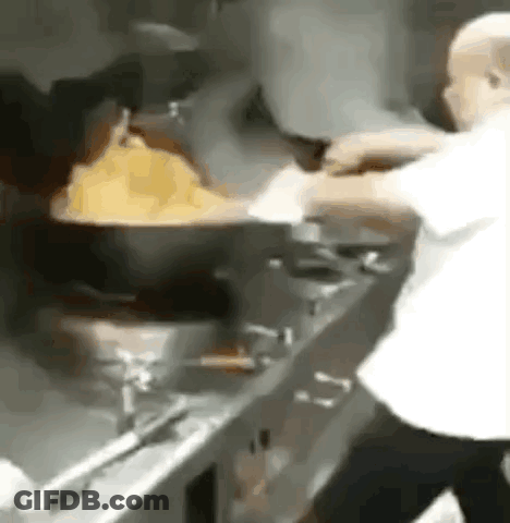 Man Cooking In Kitchen With Large Pot GIF