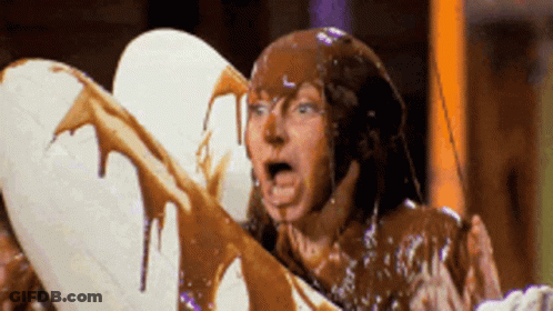Man Covered In Chocolate Holding White Heart GIF