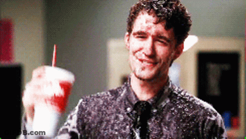 Man Covered In Foam Holding Cup With Red Straw GIF