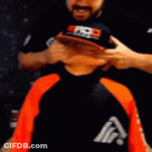 Man Covering Child's Eyes With Hat Letter A GIF