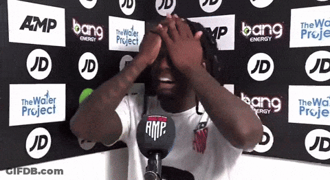 Man Covering Eyes In Front Of Bang Energy Wall GIF