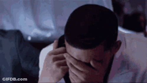 Man Covering Eyes While Talking On Cell Phone GIF