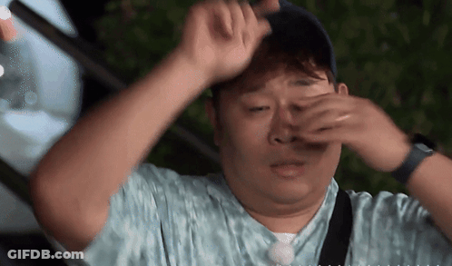Man Covering Eyes With Hands Wearing Hat GIF