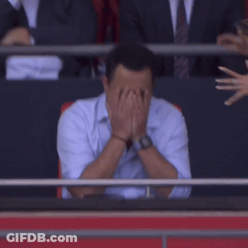 Man Covering Face As Woman Looks On GIF