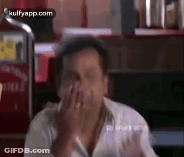 Man Covering Face At Restaurant Table GIF