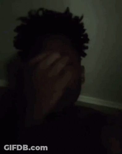 Man Covering Face In Dark GIF