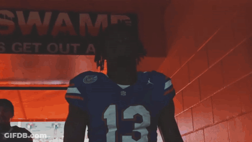 Man Covering Face In Florida Gators Jersey GIF