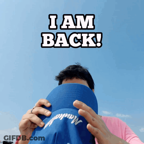 Man Covering Face With Blue Hat I Am Back GIF