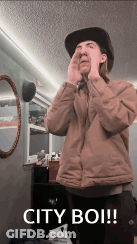 Man Covering Face With Hands And Words City Boi GIF