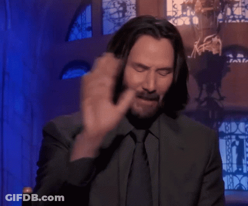 Man Covering Face With Hands In Front Of Stained Glass Window GIF