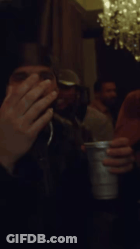 Man Covering Face With Silver Cup GIF