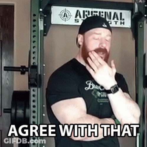 Man Covering Mouth In Front Of Arsenal Sign GIF