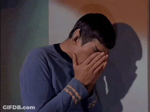 Man Covering Mouth In Front Of Orange Wall GIF