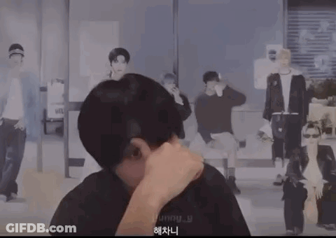 Man Covering Mouth In Front Of Painting Of Group Of Men GIF