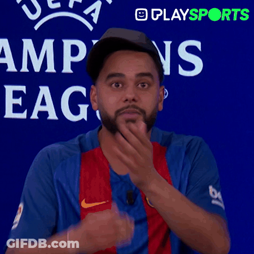 Man Covering Mouth In Front Of UEFA Champions League Sign GIF