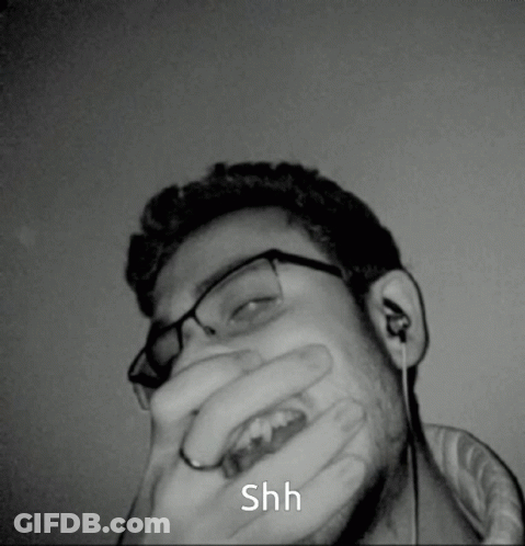 Man Covering Mouth Saying Shh GIF
